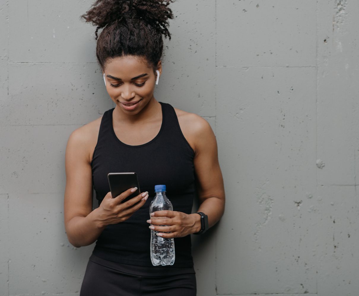 a person looking at their phone having finished a workout